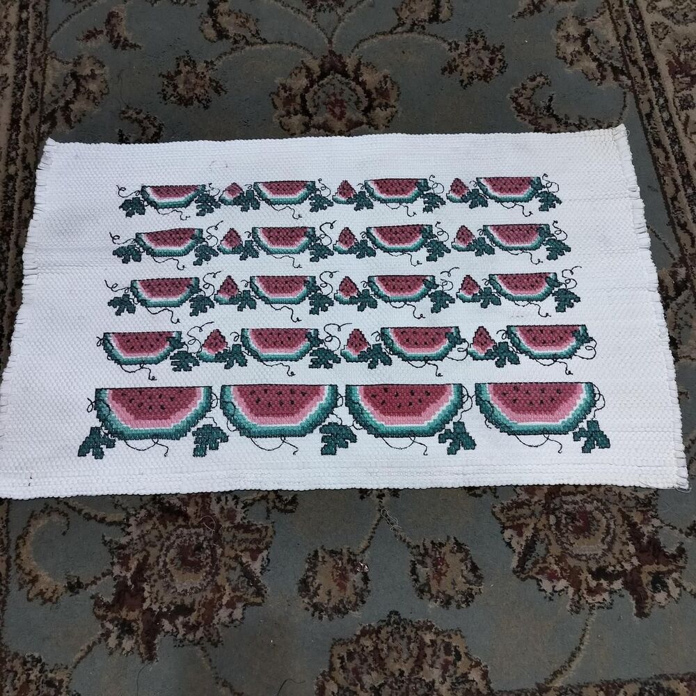 Vintage cream covered watermelon accent rug.